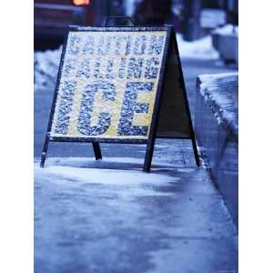 : Caution Sign Covered in Snow on Busy City Street in Ottawa, Ontario 