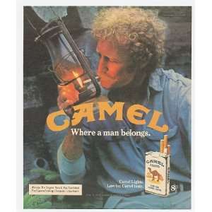   Camel Man Lighting Cigarette with Lantern Print Ad (11748): Home