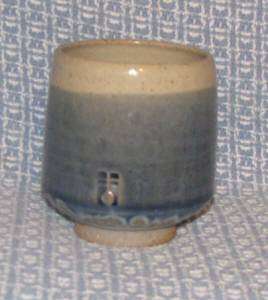  dark blue glaze ending with a row of drips onto a khaki green bottom